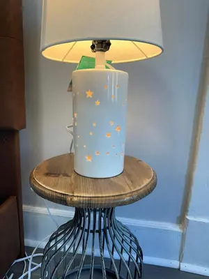 a lamp on a table with a bucket on it at Perfect stay for couples in Springfield