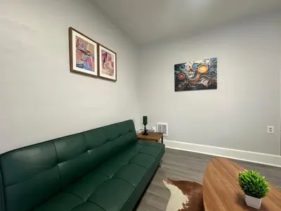 a living room with a green couch and a table at Perfect stay for couples in Springfield