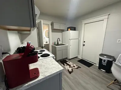 a small kitchen with a white refrigerator and a stove at Perfect stay for couples in Springfield