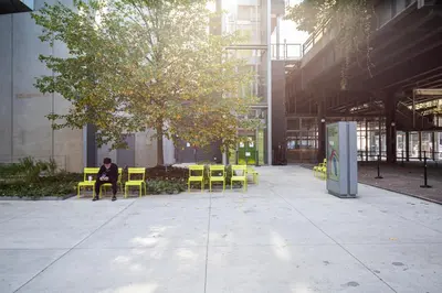 a person sitting on a chair under a tree in a building at Chelsea 1br w doorman lounge nr food hall NYC-1196 in New York