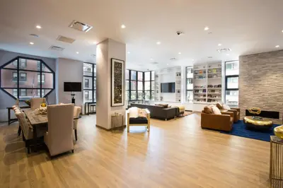 a living room with a table and chairs at Theater District Studio w Indoor pool NYC-142 in New York