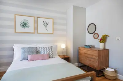 a bedroom with a bed and a wooden dresser at Theater District Studio w Indoor pool NYC-142 in New York