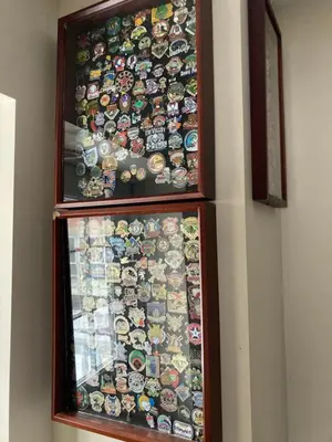 a display case filled with different types of buttons at The Hotel Pratt in Cooperstown