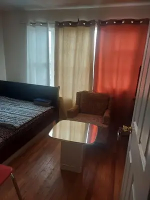 a living room with a couch and a coffee table at Crystal Room 1 Guest House near 12mins to EWR airport / Prudential / NJIT / Penn station in Newark