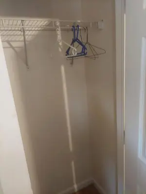a room with a closet with a shelf and a door at Crystal Room 1 Guest House near 12mins to EWR airport / Prudential / NJIT / Penn station in Newark