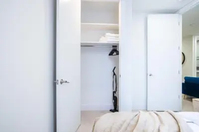 a bedroom with white walls and a bed with a mirror at 180-2 Brand new 2BR 1Bath East Village in New York