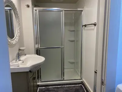 a bathroom with a shower and a sink at Water Street Apartments in Williamstown