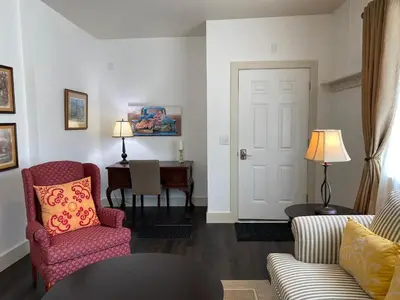 a living room with two chairs and a table at Water Street Apartments in Williamstown