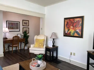 a living room with a chair and a desk at Water Street Apartments in Williamstown