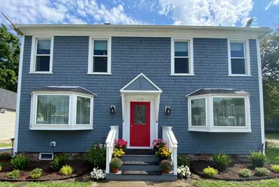 a blue house with a red door at Water Street Apartments in Williamstown