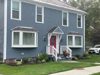 a blue house with a red door at Water Street Apartments in Williamstown