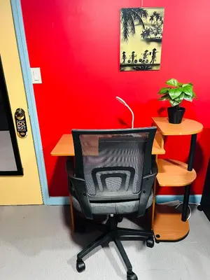 an office with a desk with a chair and a television at Single Room with Bathroom in Irvington