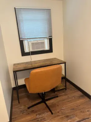 a desk with a chair in a room with a window at The Flying Dutchman Cottage in amenities filled Masthope community Ski Big Bear in Lackawaxen