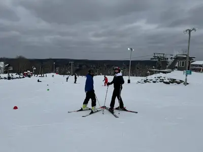 two people standing on skis in the snow at The Flying Dutchman Cottage in amenities filled Masthope community Ski Big Bear in Lackawaxen