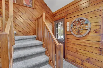 a staircase in a cabin with a wooden wall at Cabin in Long Pond Gameroom Pool Table in Long Pond