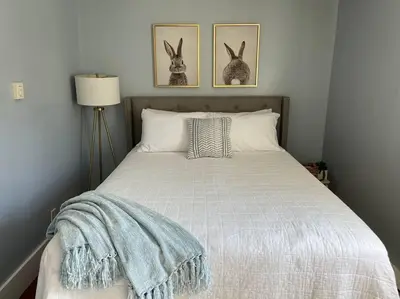a bedroom with a bed with two rabbits on the wall at Catskills Quaint Cottage with Peloton Minutes from Hiking in Mount Tremper