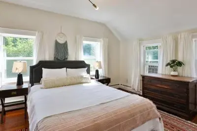 a bedroom with a large bed and two windows at Catskills Country House with Hot Tub near River Trails in Mount Tremper