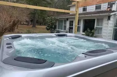 a hot tub with water in it in front of a house at Catskills Country House with Hot Tub near River Trails in Mount Tremper