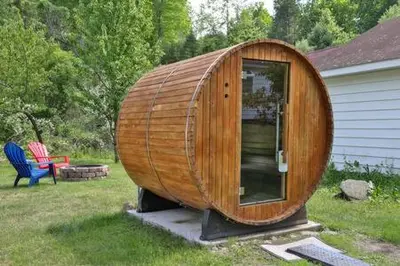 a wooden boat sitting in the grass next to a house at Catskills Country House with Hot Tub near River Trails in Mount Tremper