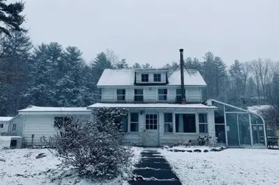 a white house with snow on its roof at Catskills Country House with Hot Tub near River Trails in Mount Tremper