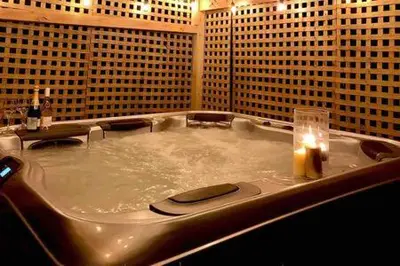 a bathroom with a tub with a candle in it at Catskills Country House with Hot Tub near River Trails in Mount Tremper