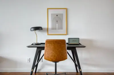 a desk with a chair and a laptop on it at Blueground UES gym balcony nr central park NYC-1404 in New York
