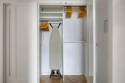a dressing room with a dresser and a mirror at Blueground UES gym balcony nr central park NYC-1404 in New York