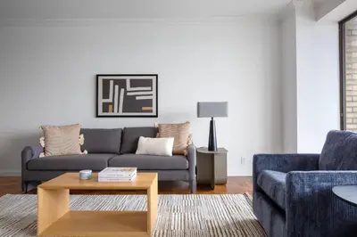 a living room with a couch and a coffee table at Blueground UES gym balcony nr central park NYC-1404 in New York