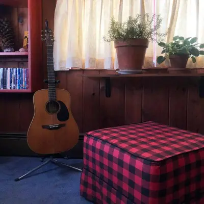 a guitar sitting in a room next to a table at Panther Mountain Lodge in Phoenicia