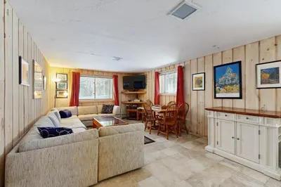 a living room with a couch and a table at Bear's Crossing Retreat in Dover