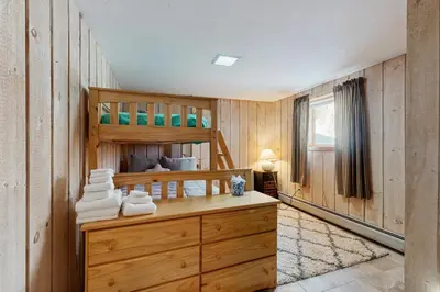a bedroom with a bunk bed and a desk with towels at Bear's Crossing Retreat in Dover