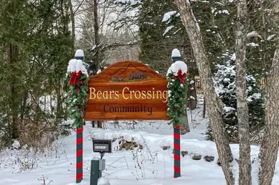 a sign for a bears crossing community in the snow at Bear's Crossing Retreat in Dover