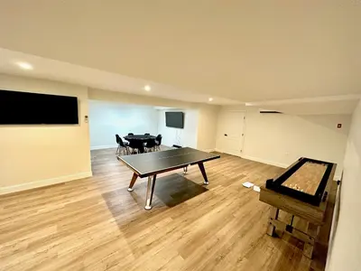 a living room with a ping pong table in it at New Farmhouse, King Beds, Game Room, Hot Tub & View! in Montgomery