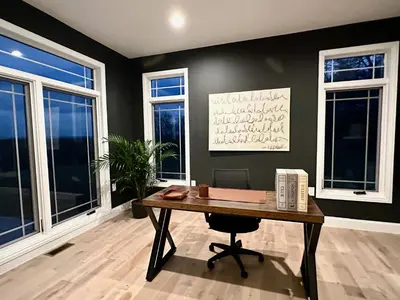 an office with a wooden desk and windows at New Farmhouse, King Beds, Game Room, Hot Tub & View! in Montgomery