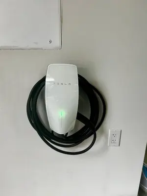 a computer mouse on a black cord next to an outlet at New Farmhouse, King Beds, Game Room, Hot Tub & View! in Montgomery