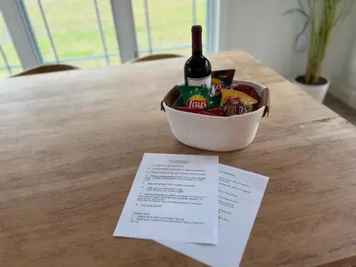 a basket of food and a bottle of wine on a table at New Farmhouse, King Beds, Game Room, Hot Tub & View! in Montgomery