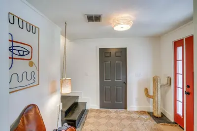 a hallway with a door and a chair in a room at Secluded Catskill Home with Hiking Trails On-Site! in Catskill