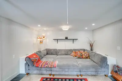 a living room with a gray couch in a room at Secluded Catskill Home with Hiking Trails On-Site! in Catskill