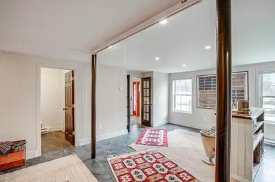 an open living room with white walls and windows at Secluded Catskill Home with Hiking Trails On-Site! in Catskill