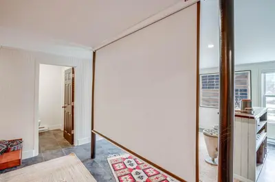 a large mirror in a room with a staircase at Secluded Catskill Home with Hiking Trails On-Site! in Catskill