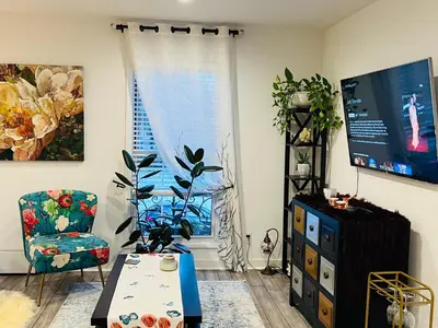 a living room with a table and a window at Eleni’s Charming Studio in North Beach