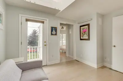 a living room with a couch and a window at Bright Milford Beach House with Outdoor Shower in Milford