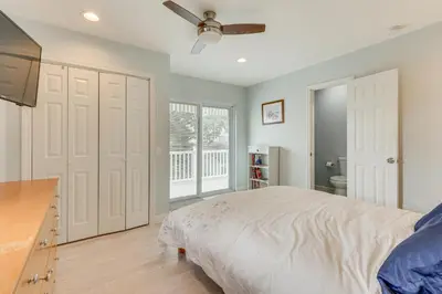 a bedroom with a bed and a ceiling fan at Bright Milford Beach House with Outdoor Shower in Milford