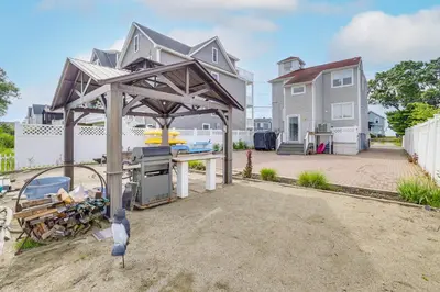 a house being built with a grill in the yard at Bright Milford Beach House with Outdoor Shower in Milford