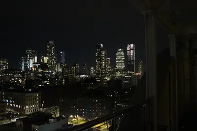 a view of a city skyline at night at Romana Hotel - NYC in Queens