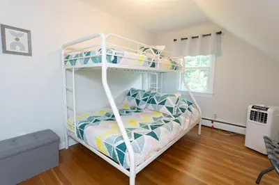 a bedroom with a bunk bed in a room at 14mi to Mt. Snow! Arcade, Private Suite, King Bed! in Whitingham