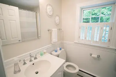 a white bathroom with a sink and a toilet at 14mi to Mt. Snow! Arcade, Private Suite, King Bed! in Whitingham
