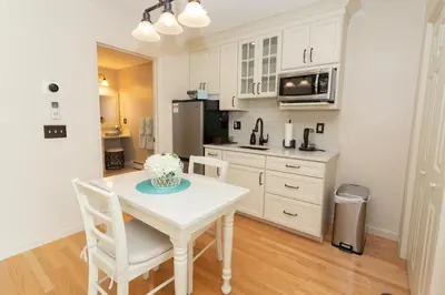 a kitchen with a table and chairs in a room at 14mi to Mt. Snow! Arcade, Private Suite, King Bed! in Whitingham