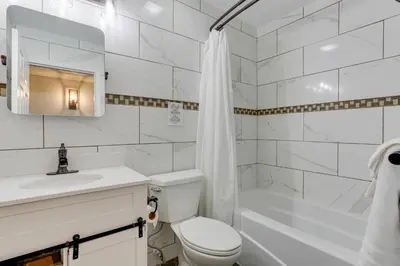 a white bathroom with a toilet and a sink and a tub at East Stroudsburg Townhouse Less Than 1 Mi to Ski Area! in East Stroudsburg