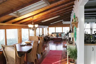 a dining room and living room with a table and chairs at Enchanted Woodstock Cottage with hot tub in West Hurley